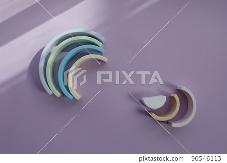 Children's wooden eco-friendly toys. A semicircle. Color Rainbow Colors: blue, light green, dark white on a gray background. View from above Children's wooden eco-friendly toys. A semicircle. Color Rainbow Colors: blue, light green, dark white on a gray background. View from above 90546113