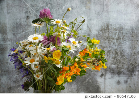 Beautiful bouquet of wildflowers on dark background. Beautiful bouquet of wildflowers on dark background. 90547106