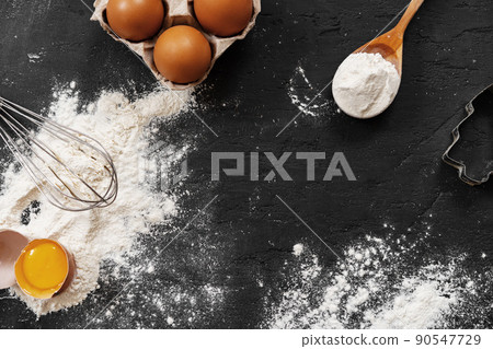 Preparation for baking. Eggs and flour on black background 90547729