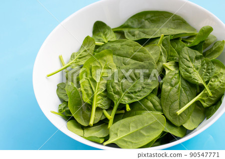 Spinach leaves on white background. Spinach leaves on white background. 90547771
