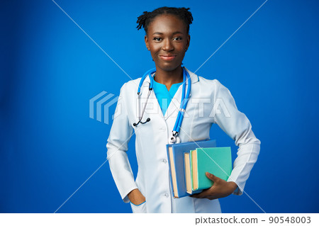 Black female doctor student wearing a lab coat with book 90548003