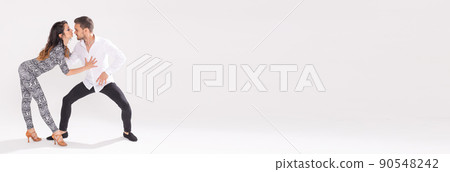 Banner social dance bachata kizomba zouk tango - Man hugs woman while dancing on white background with copy space Banner social dance bachata kizomba zouk tango - Man hugs woman while dancing on white background with copy space 90548242