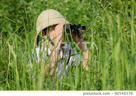 Young explorer with binoculars on safari 90548376