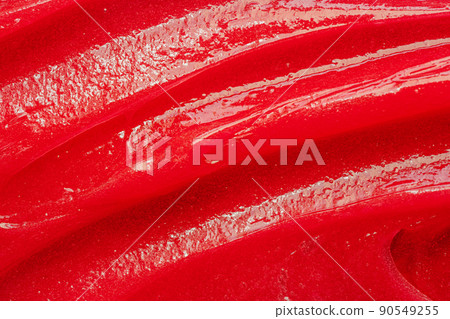 Red gel texture. Cosmetic clear liquid cream smudge. Skin care product sample closeup. Toothpaste or wax 90549255