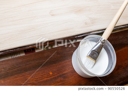 Selective focus. A container with paint and a brush. Selective focus. A container with paint and a brush. 90550526