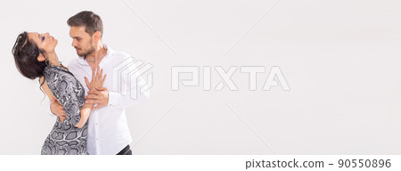 Banner dance concept - Active happy adults dancing bachata or salsa kizomba together over white background with copy space Banner dance concept - Active happy adults dancing bachata or salsa kizomba together over white background with copy space 90550896
