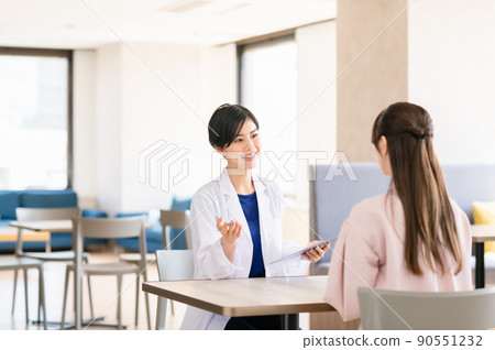 Female doctor interviewing a patient Female doctor interviewing a patient 90551232