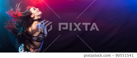 Banner young woman dancing in Tribal Fusion style with copy space. Belly dance on the stage. 90551541