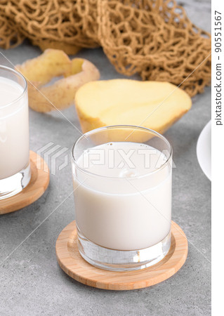 Vegan potato milk and potato on grey stone table background. Plant based alternative milk replacer and lactose free 90551567