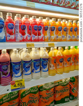 SELANGOR, MALAYSIA -JULY 11, 2021: Selected focused on yogurt drinks and other dairy products displayed for sale in the huge chiller, sorted by the brand to make it easy for the customer to choose. SELANGOR, MALAYSIA -JULY 11, 2021: Selected focused on yogurt drinks and other dairy products displayed for sale in the huge chiller, sorted by the brand to make it easy for the customer to choose. 90551576