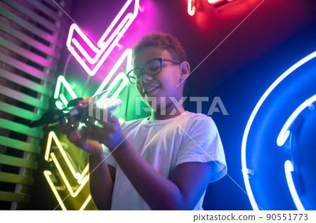 Pleased teenager in eyeglasses playing with his toy helicopter 90551773