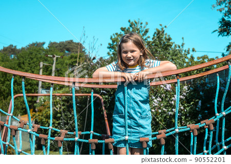 Filter photo. Six years old kid face in summer time outdoors. Portrait of little girl on playground. Happy smiling joyful kid, true emotion, carefree childhood concept. Filter photo. Six years old kid face in summer time outdoors. Portrait of little girl on playground. Happy smiling joyful kid, true emotion, carefree childhood concept. 90552201