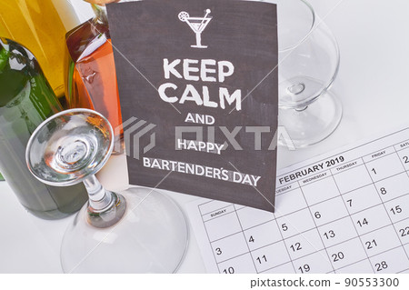 Bartenders day concept. February calendar and many alcoholic drinks. 90553300