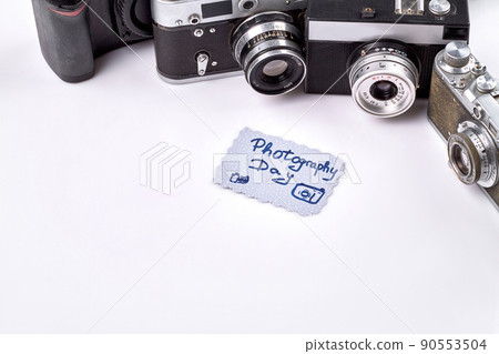 Photography day on the paper. Old retro vintage photo cameras. Photography day on the paper. Old retro vintage photo cameras. 90553504