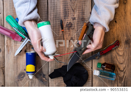 Take care of the instrument. Take care of your knives. Maintenance of knives and tools. Oil and knife in hand. 90553831