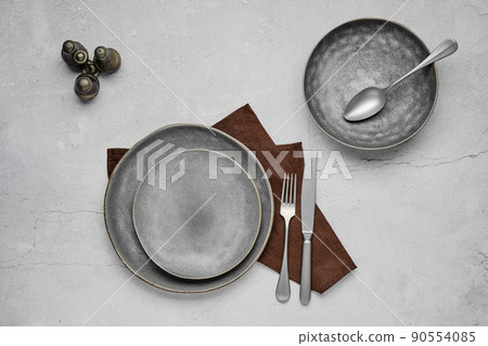 Set of grey ceramic plates and tableware, top view 90554085