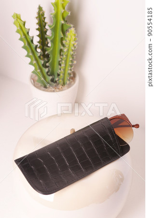 brown crocodile leather eyeglass case closeup photo on white wall background 90554185