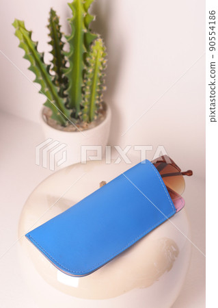 blue leather eyeglass case closeup photo on white wall background blue leather eyeglass case closeup photo on white wall background 90554186