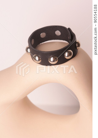 leather studded black bracelet closeup photo on white wall background leather studded black bracelet closeup photo on white wall background 90554188