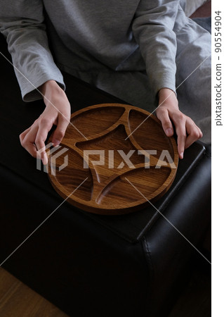 Wooden round menagerie in women's hands 90554904