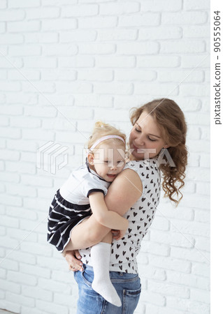 Baby with cochlear implant hearing aid having fun with her mother - deafness and diversity concept. Copy space and place for advertising Baby with cochlear implant hearing aid having fun with her mother - deafness and diversity concept. Copy space and place for advertising 90555064