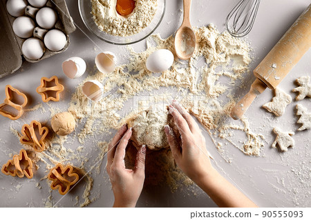 Baking preparation. Raw dough and cutters for the holiday cookies on a white table. Top view. 90555093