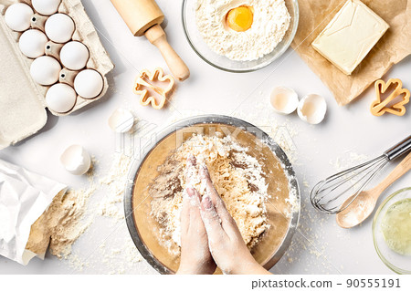 Baker preparing to knead the dough, top view. Cooking, bakery concept Baker preparing to knead the dough, top view. Cooking, bakery concept 90555191
