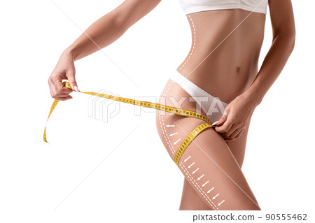 Female body with the drawing arrows on it isolated on white. Fat lose, liposuction and cellulite removal concept. Female body with the drawing arrows on it isolated on white. Fat lose, liposuction and cellulite removal concept. 90555462
