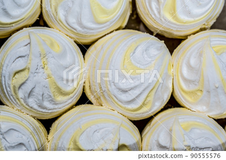 Marshmallows of different colors are laid out on trays. Fresh homemade marshmallow before packing. 90555576