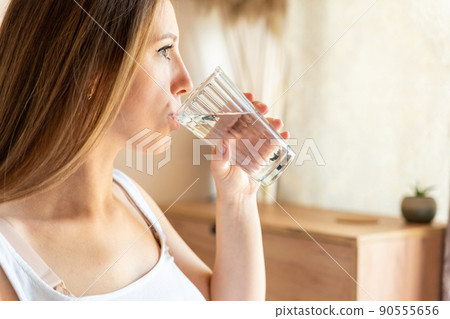 Pregnant drink water. Beautiful pregnancy drinking water. Happy pregnant lady holding glass of water. Pregnancy, maternity, healthcare concept. 90555656