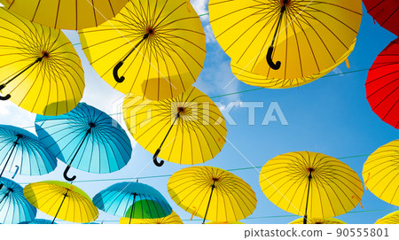 Colorful umbrellas background. Colorful umbrellas in blue sky. Street decoration 90555801
