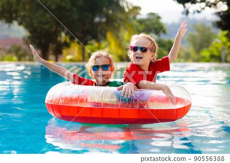 Kids in swimming pool. Life jacket for child. 90556388
