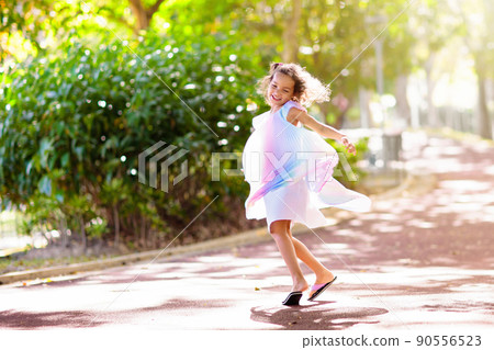 Happy kid playing in summer park Happy kid playing in summer park 90556523