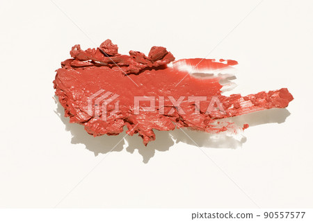 Cosmetics lipstick swatches. Peach, beige, red and coral toned styled cosmetics flat lay. Closeup colour palette. Creative concept photo of cosmetics samples isolated on white background 90557577
