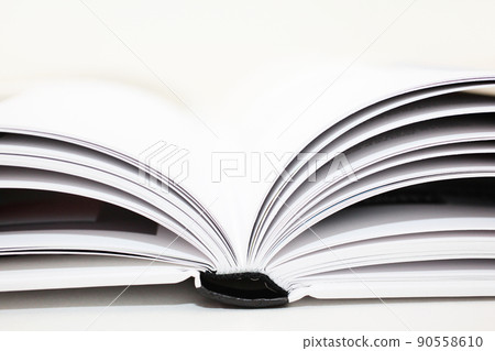 Books that are left open on the table in the middle of research Books that are left open on the table in the middle of research 90558610