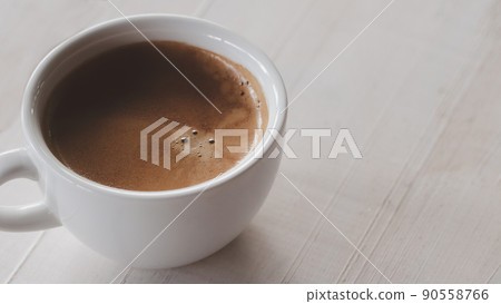 Close up hot cooffee espresso in white cup on white wood table. 90558766