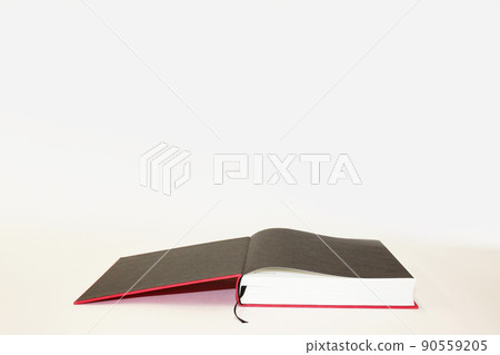 Books that are left open on the table in the middle of research 90559205