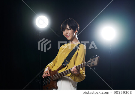 Female guitarist black background Female guitarist black background 90559368
