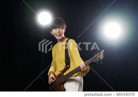 Female guitarist black background Female guitarist black background 90559370