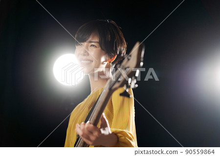 Female guitarist black background 90559864