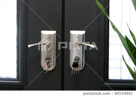 Padlock hangs on an iron closed gate with peeling paint and rust 90559991