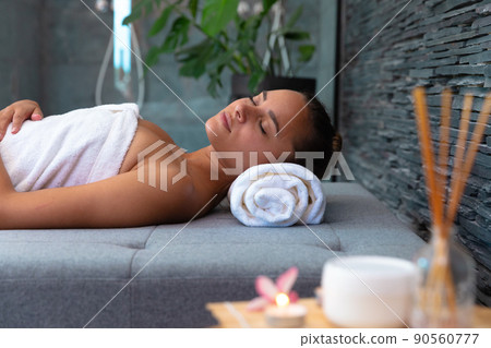 Caucasian young woman in a bathrobe relaxing on the massage table 90560777