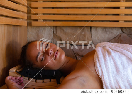 Caucasian young woman in a bathrobe relaxing in the sauna Caucasian young woman in a bathrobe relaxing in the sauna 90560851