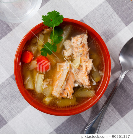 Salmon backbone fish soup with potatoes and carrots in clay bowl Salmon backbone fish soup with potatoes and carrots in clay bowl 90561357