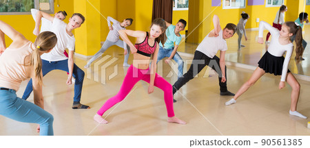 Tweens exercising with coach in choreography class Tweens exercising with coach in choreography class 90561385