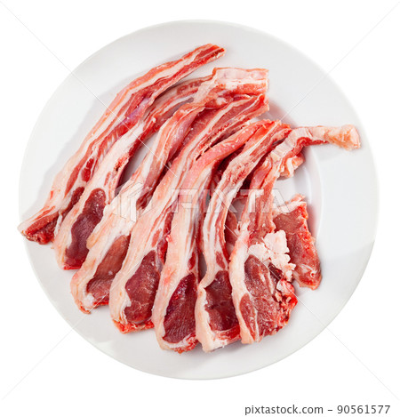 Raw lamb chops on plate, over white background Raw lamb chops on plate, over white background 90561577