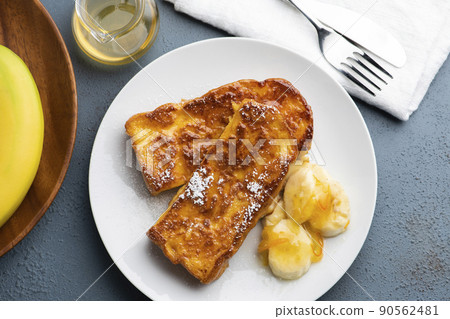 A bird's-eye view of caramel French toast with a crispy and fluffy texture with banana and orange marmalade 90562481