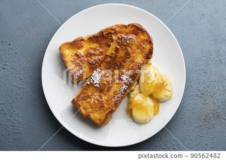 A bird's-eye view of caramel French toast with a crispy and fluffy texture with banana and orange marmalade 90562482