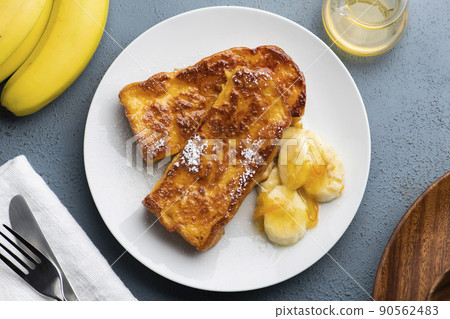 A bird's-eye view of caramel French toast with a crispy and fluffy texture with banana and orange marmalade 90562483