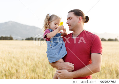 Father playing and carrying his daughter on hands.Mature man playing with his little daughter in nature.Dad playing with daughter in park and hugging her. Father playing and carrying his daughter on hands.Mature man playing with his little daughter in nature.Dad playing with daughter in park and hugging her. 90562768